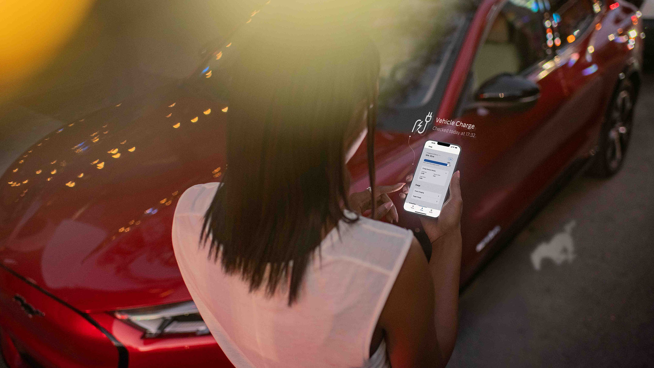 Person looking at smartphone with Ford app displayed